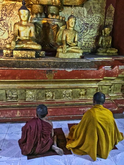 2 monks at Buddhist altar